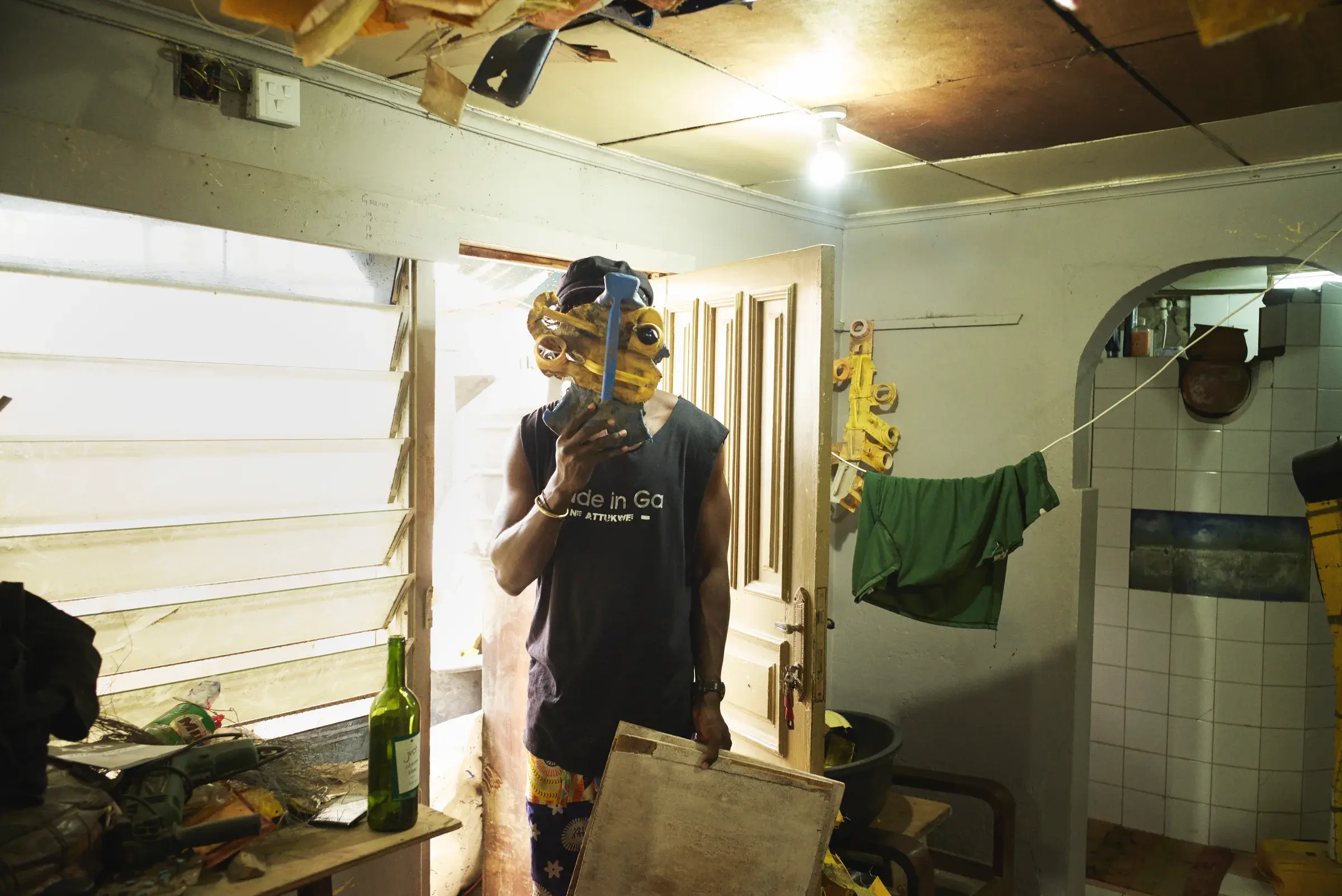 Serge Attukwei Clottey in his Accra studio surrounded by materials and work in progress, Photography Julien Lanoo