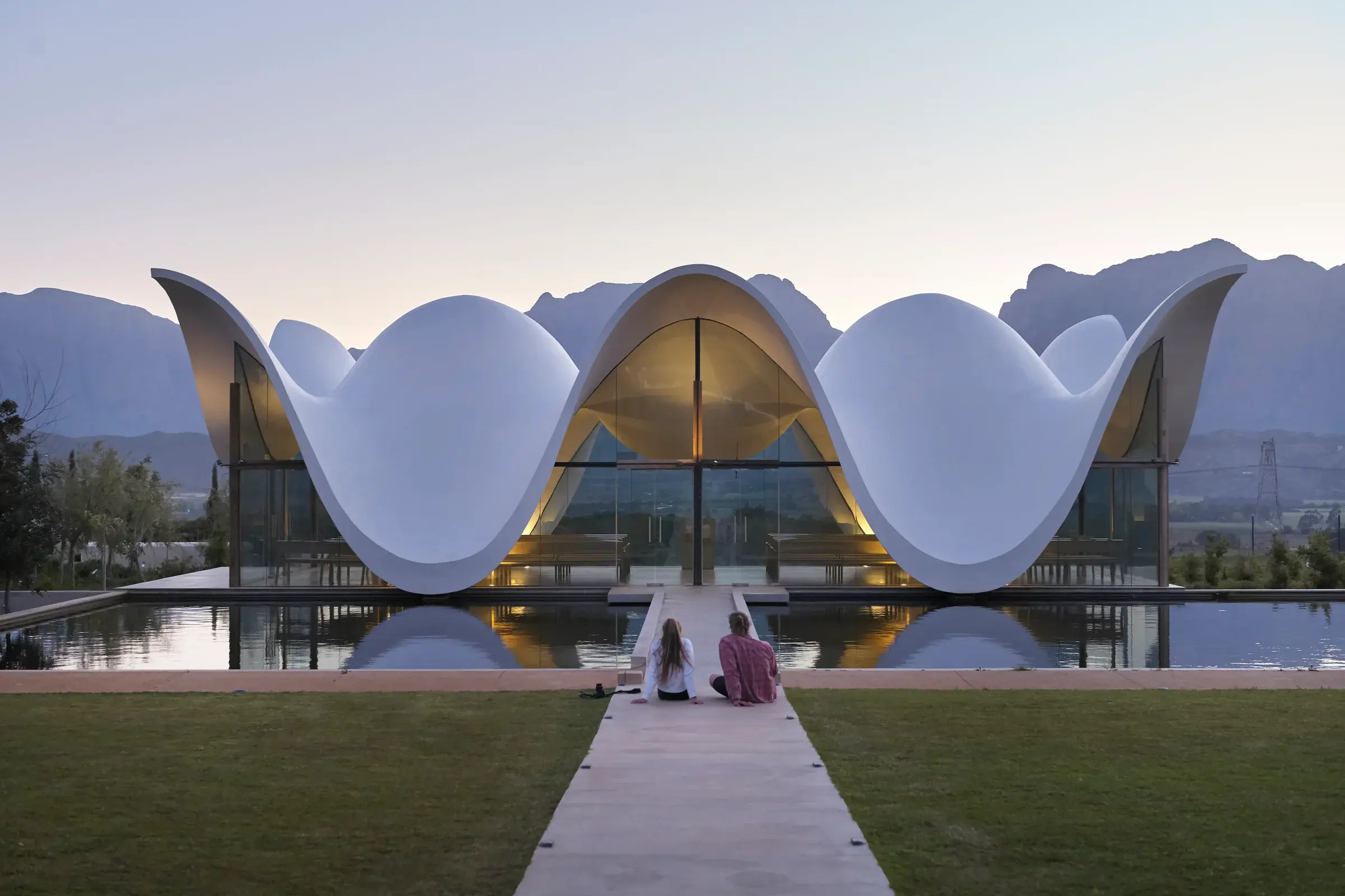 Bosjes Chapel by Steyn Studio in Breede Valley, South Africa, with its white concrete shell and reflected setting, Photography Julien Lanoo
