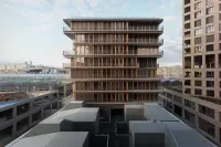 Chapelle International residential tower with sculptural white concrete exoskeleton, Paris, France