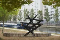 Dancing Forest by Kengo Kuma on the Saint-Cyr quays in Rennes, France, with burnt wooden trunks and Photography Julien Lanoo