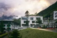 Engelberg School in Engelberg, Switzerland, by Rahbaran Hürzeler Architekten & BGM Architekten, with Alpine surroundings and Photography Julien Lanoo.