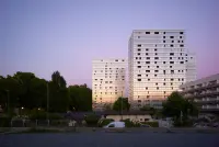 Renewed building base and façade at the Génicart District Renovation, Lormont, France