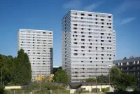 Residential block in the Génicart District Renovation, Lormont, France, showing façade rehabilitation and a clearer building base.