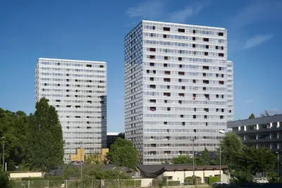 Residential block in the Génicart District Renovation, Lormont, France, showing façade rehabilitation and a clearer building base.