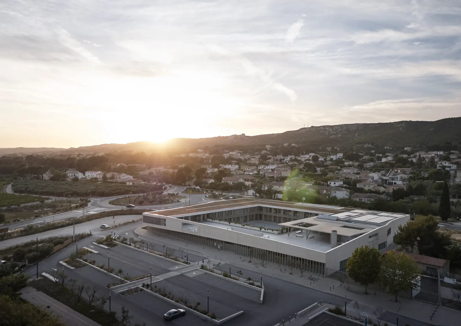Courtyard view of the school with stacked volumes and sheltered circulation in La Fare-les-Oliviers