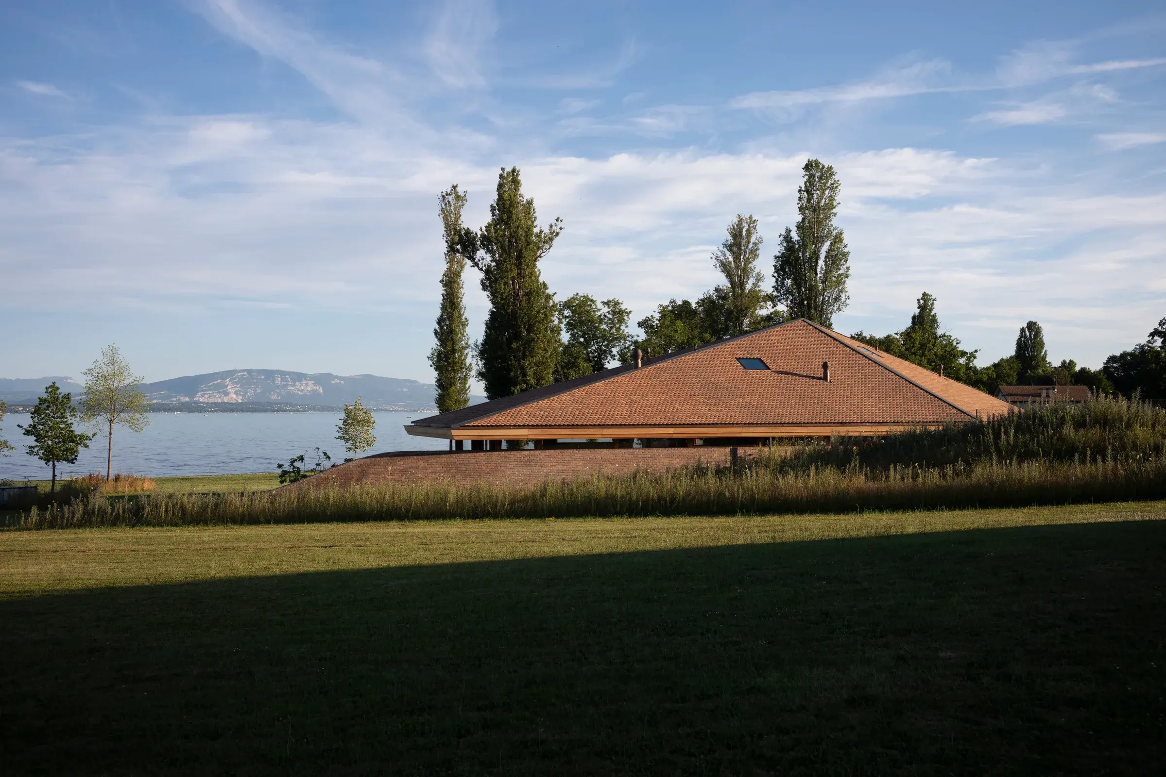House by the Lake by FdMP Architectes in Geneva, set against the slope and lake, Photography Julien Lanoo