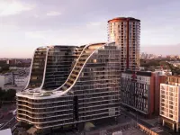 Infinity residential tower in Sydney, Australia, by Koichi Takada Architects, viewed across the landscaped courtyard