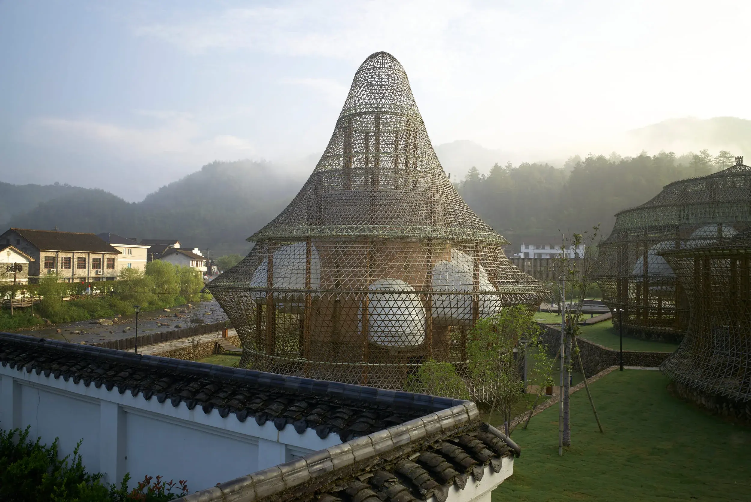 Participants at the International Bamboo Architecture Biennale in Baoxi, China, with bamboo architecture around them, Photography Julien Lanoo
