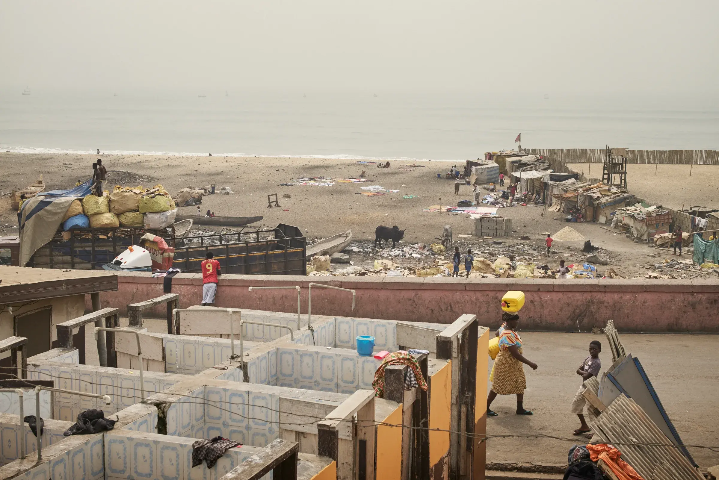 Street-level view of James Town, Accra, Ghana, with informal buildings and everyday movement, Photography Julien Lanoo