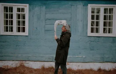 Konstantin Ikonomidis in Sarfannguit, Greenland, with a remote landscape backdrop, Photography Julien Lanoo