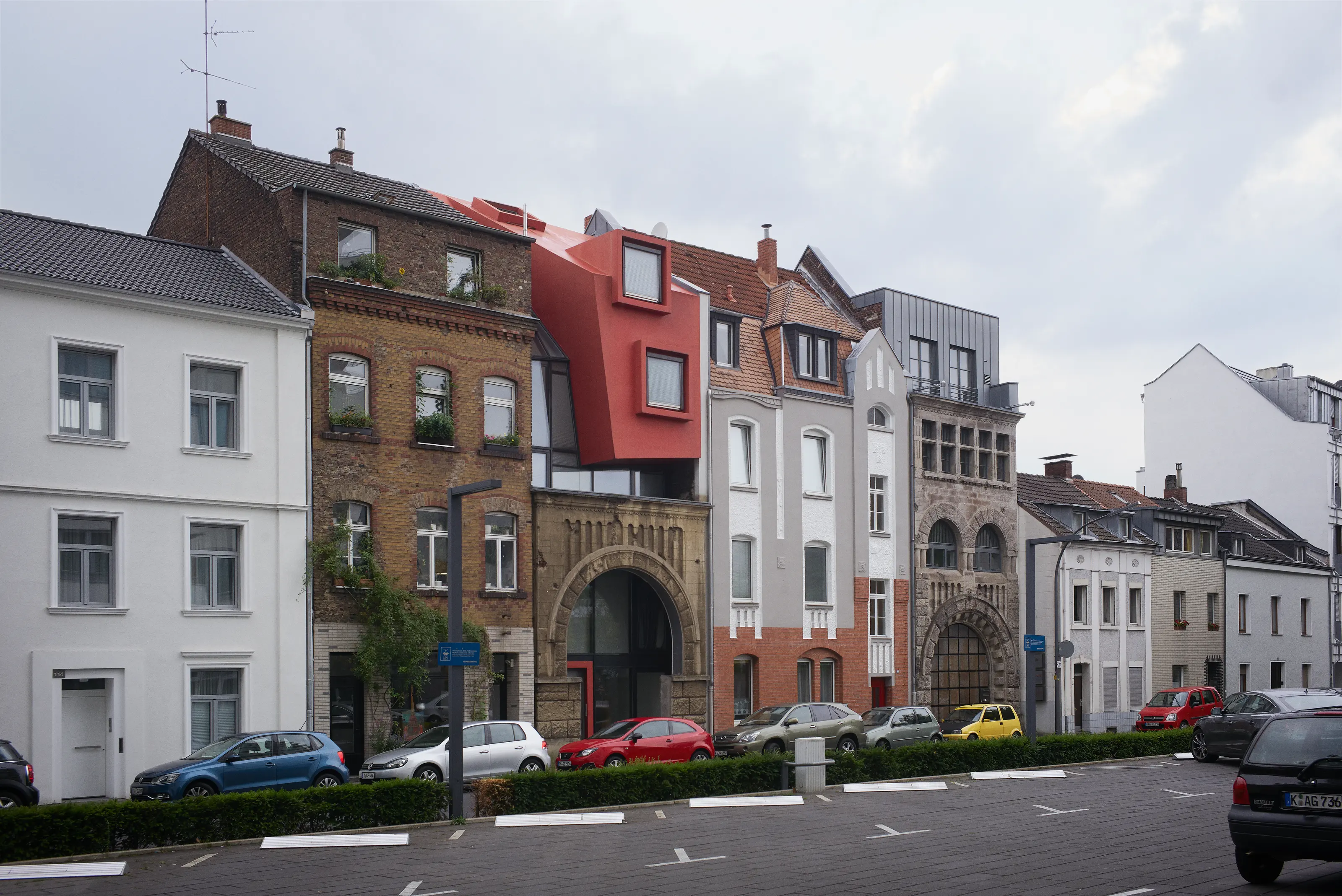 Legal | Illegal infill building in Cologne, Germany, showing a transparent orthogonal volume and sculptural red form. Photography Julien Lanoo