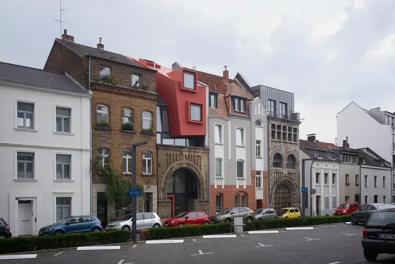 Legal | Illegal infill building in Cologne, Germany, showing a transparent orthogonal volume and sculptural red form. Photography Julien Lanoo