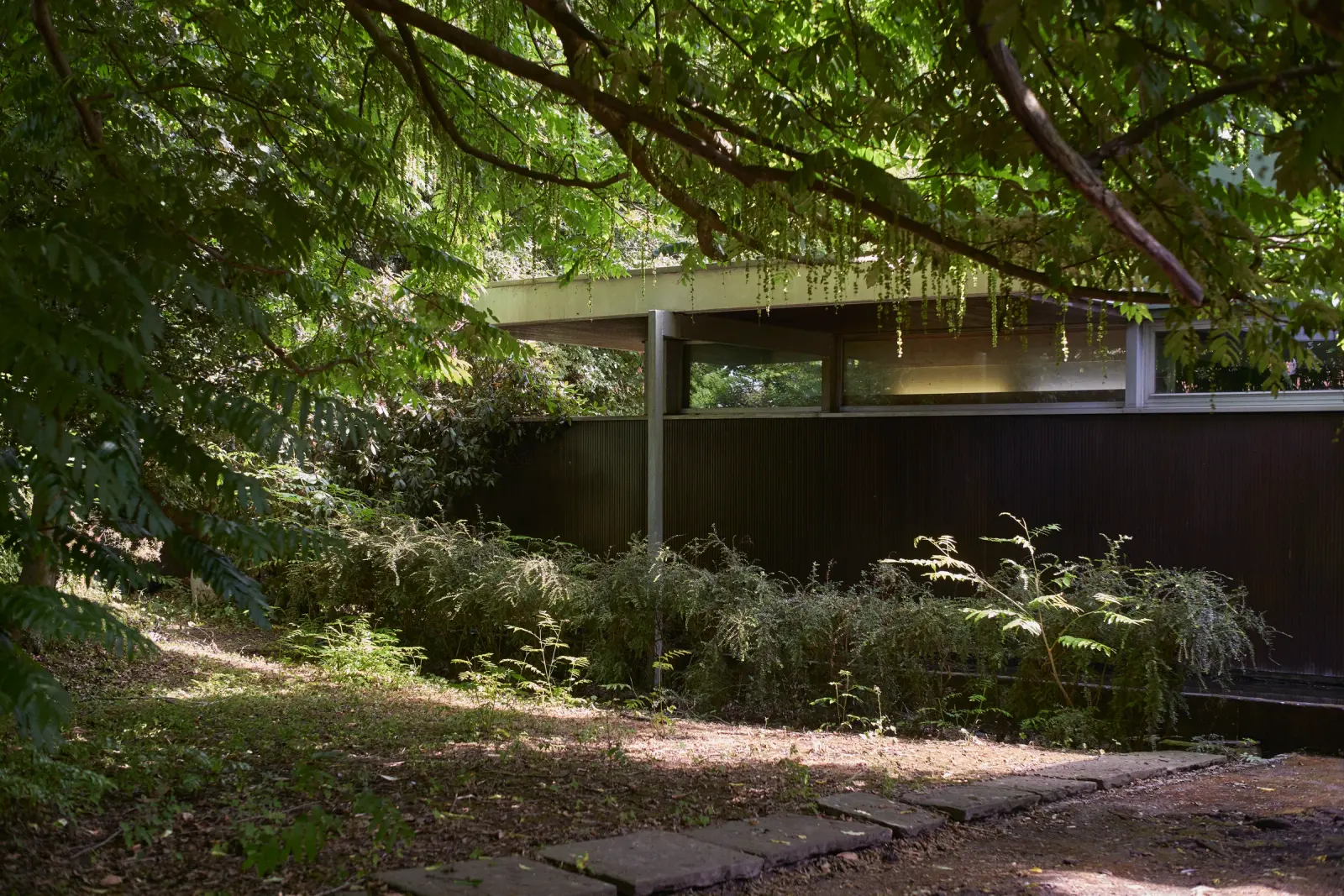Maison Delcourt — Villa Neutra in Croix, France, with a view of the modernist structure and surrounding greenery.