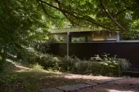 Maison Delcourt — Villa Neutra in Croix, France, with a view of the modernist structure and surrounding greenery.