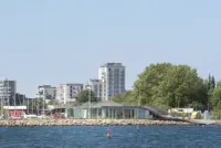 Maritime Youth House in Copenhagen with a raised timber deck and waterfront terrace, Julien De Smedt Architects and BIG