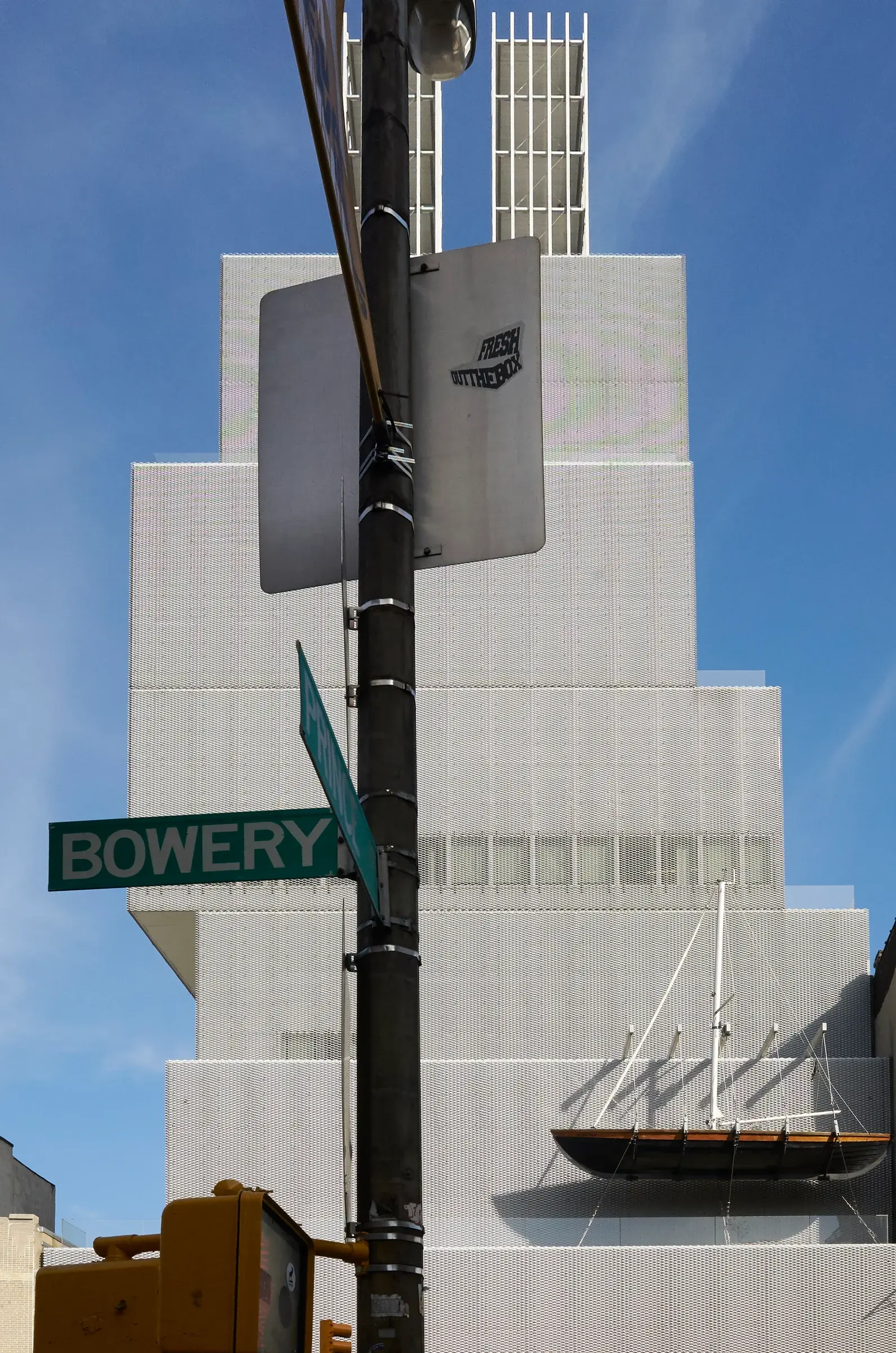 Vertical view of the New Museum of Contemporary Art in New York, showing its stacked form against the city.