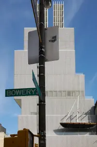 Vertical view of the New Museum of Contemporary Art in New York, showing its stacked form against the city.