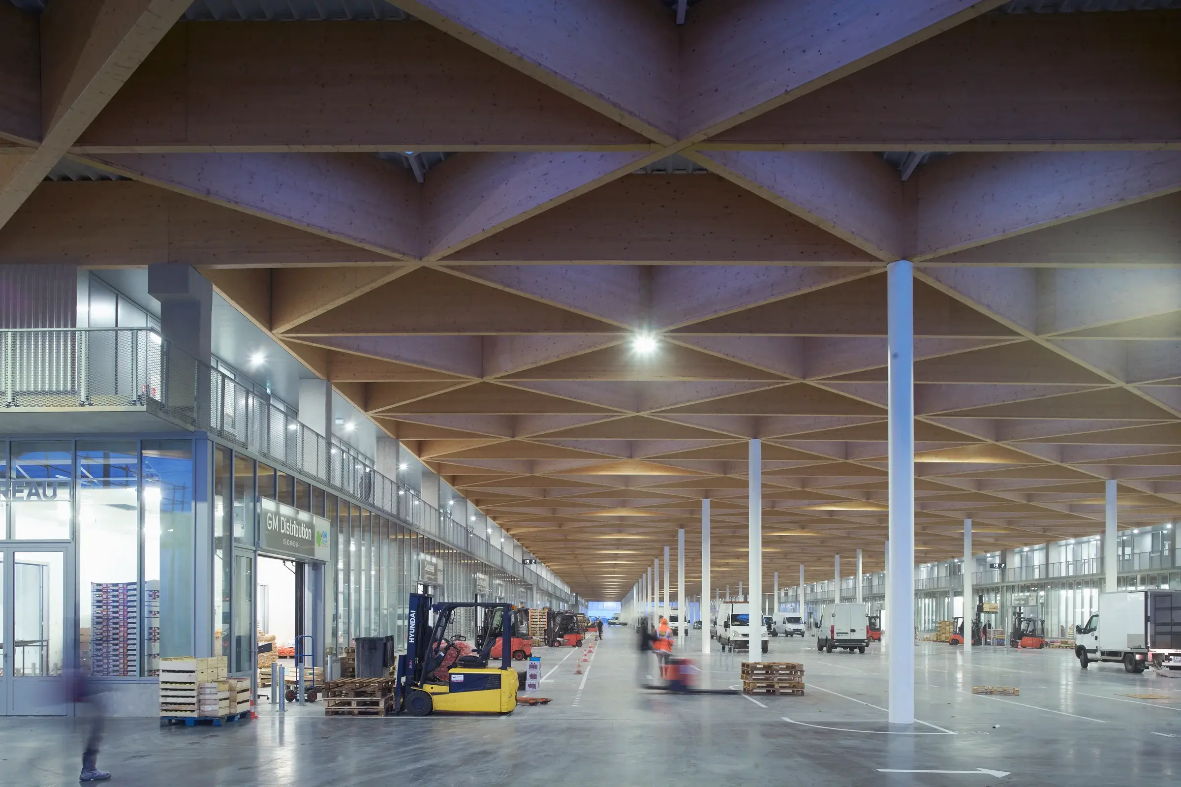 New National Wholesale Market in Nantes showing the timber roof and industrial façades, Photography Julien Lanoo