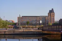 Rives de la Haute-Deûle in Lille with canal-side mixed-use buildings and landscape continuity, Photography Julien Lanoo