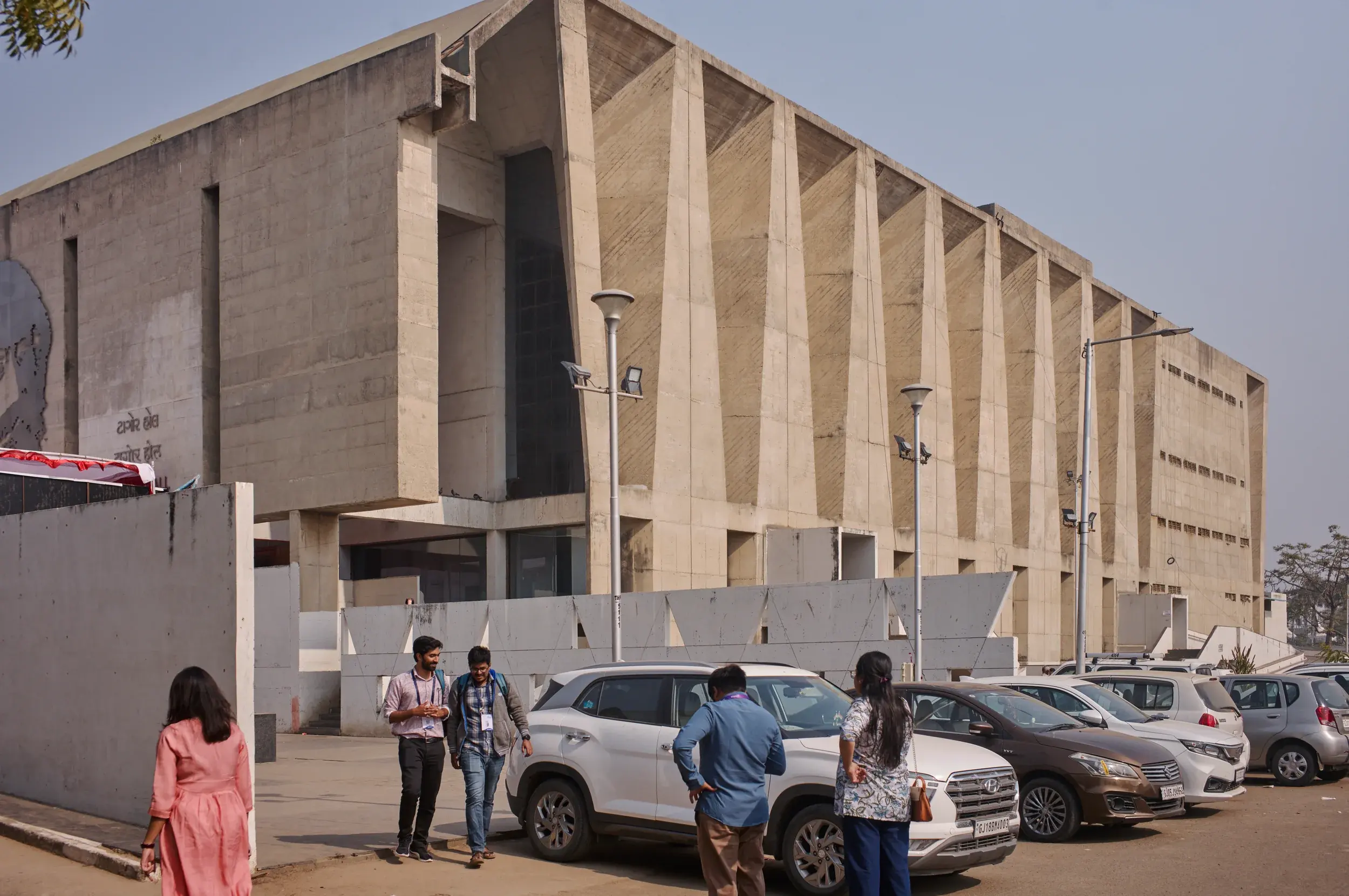 Tagore Memorial Hall in Ahmedabad with folded concrete walls and deep shadows, Photography Julien Lanoo