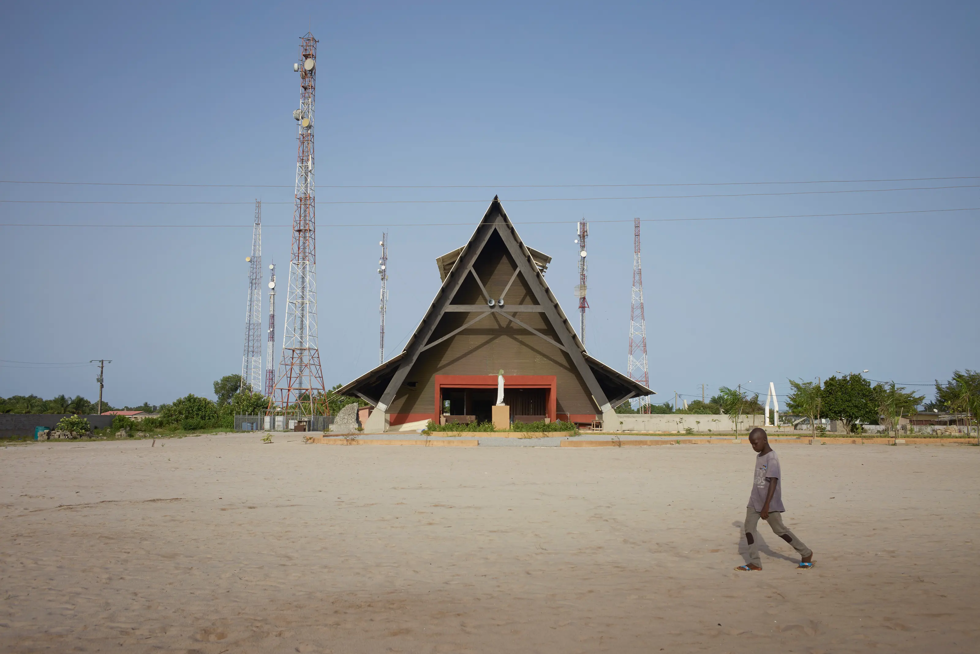 The Assinie-Mafia Church by Koffi & Diabaté Architectes in Assinie-Mafia, Côte d’Ivoire, with porous edges and a calm silhouette, Photography Julien Lanoo
