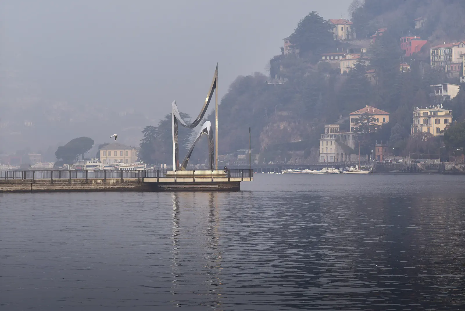 The Life Electric monument reflecting Lake Como surroundings in Como, Italy