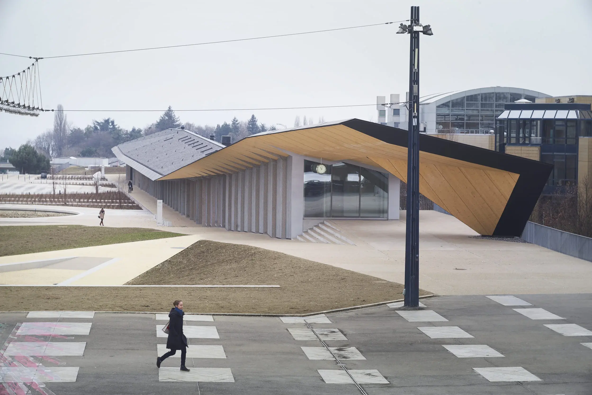 Under One Roof by Kengo Kuma in Lausanne, Switzerland, with a sweeping timber roof and transparent façades, Photography Julien Lanoo