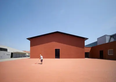 Vitra Schaudepot by Herzog & de Meuron in Weil am Rhein, Germany, with its compact brick volume and gabled roof, Photography Julien Lanoo