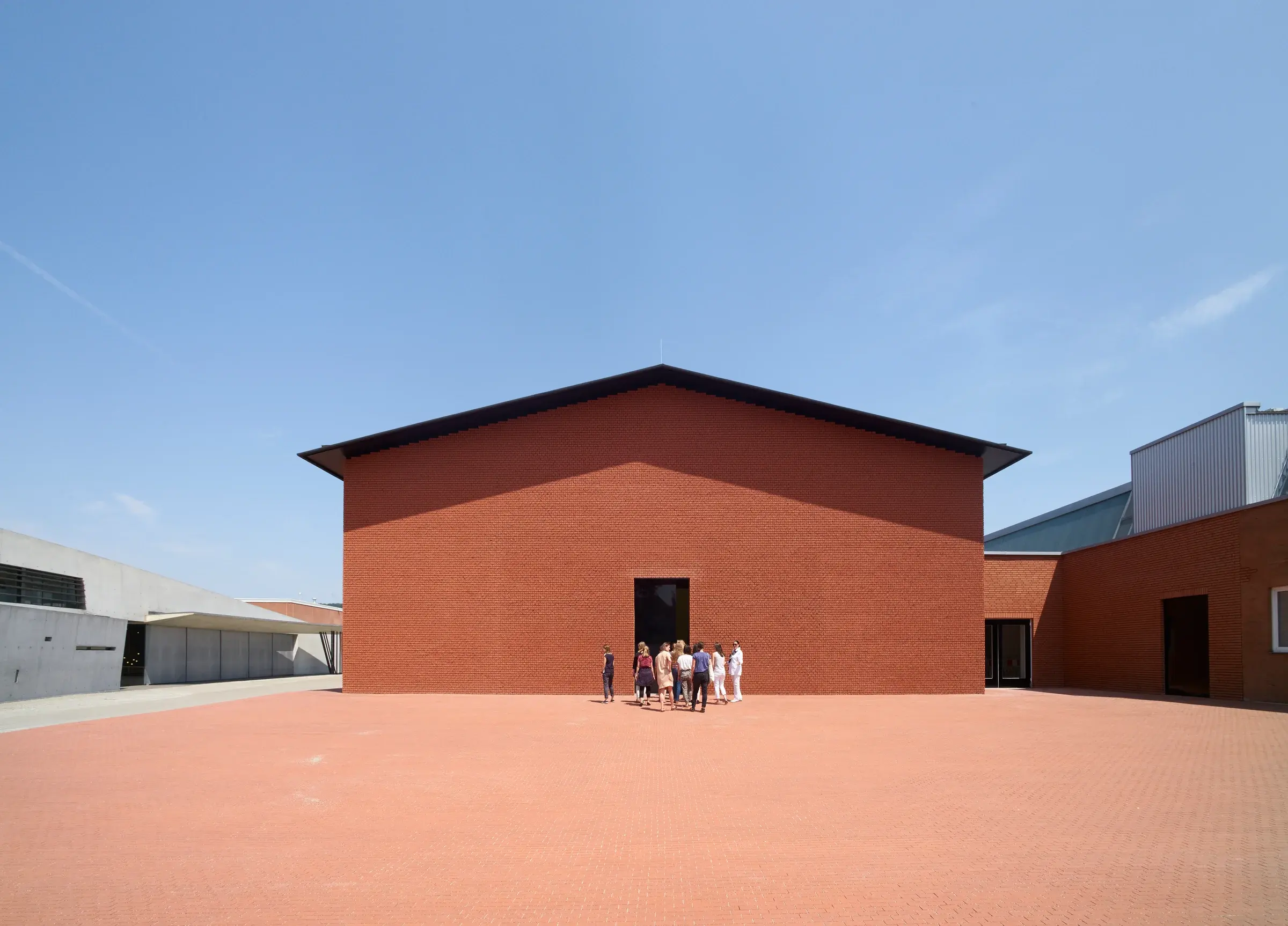 The Vitra Schaudepot archive and exhibition hall in Weil am Rhein, Germany, with a calm, windowless exterior, Photography Julien Lanoo
